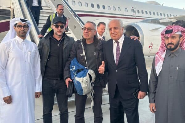 Photo: An image of a brochure published by the Qatar Ministry of Foreign Affairs shows the American citizen George Glezmann (c) posing for a photo in Kabul, March 20, 2025, before his departure to Doha.