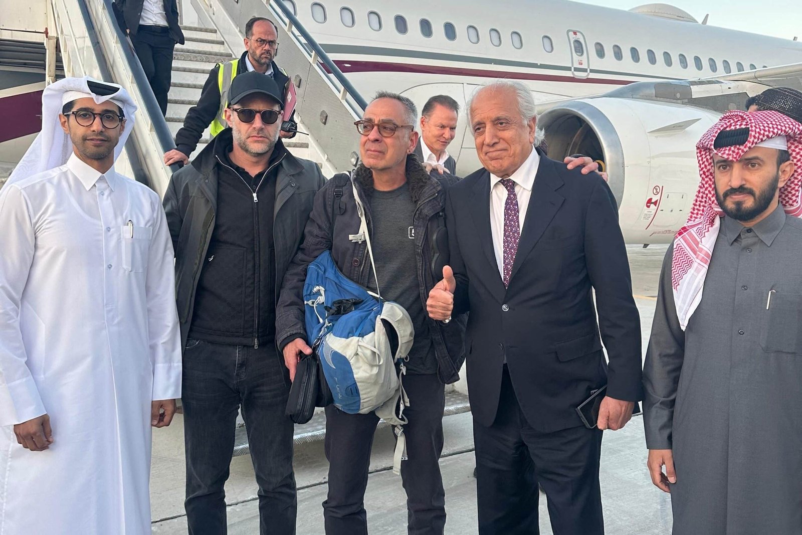 Photo: An image of a brochure published by the Qatar Ministry of Foreign Affairs shows the American citizen George Glezmann (c) posing for a photo in Kabul, March 20, 2025, before his departure to Doha.